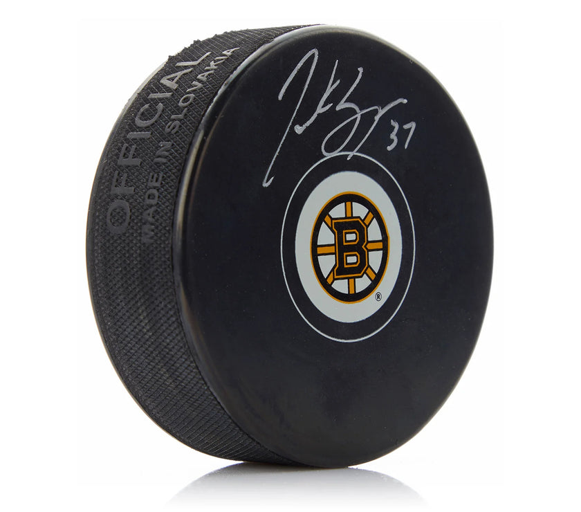 Disco de los Boston Bruins firmado por Patrice Bergeron