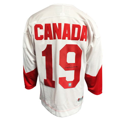 Paul Henderson admires Team Canada sweater after he was named